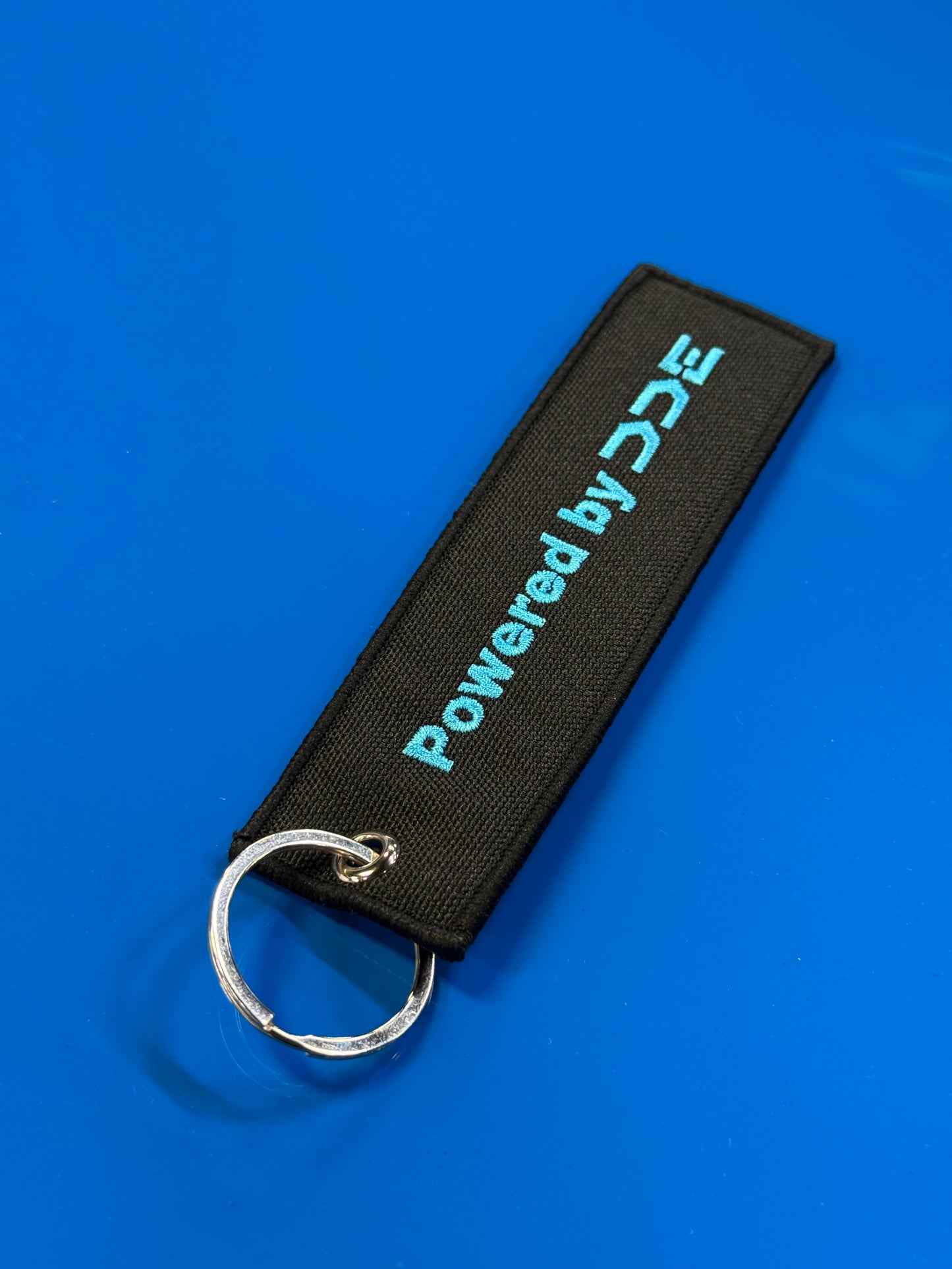 POWERED BY DDE BLACK/BLUE JET TAG